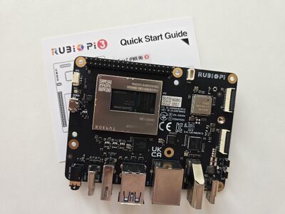 The Rubik Pi 3 board with a written quick start guide